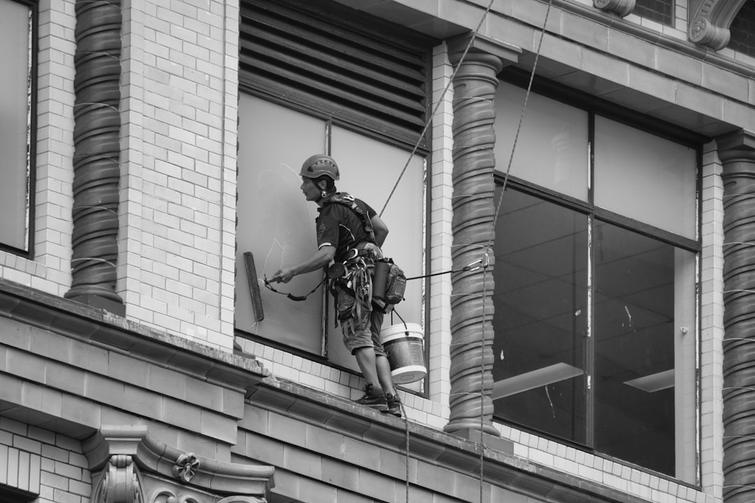 A window cleaner cleaning the windows of a building.